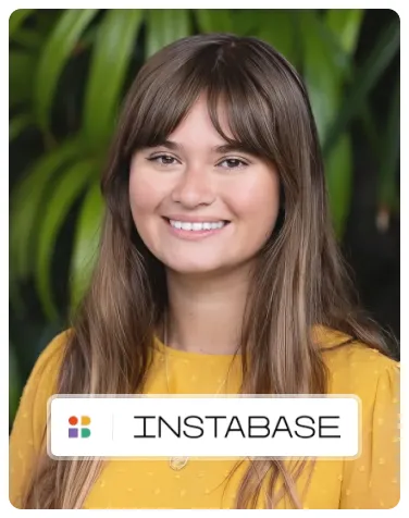 Sidra Narvaez of Instabase smiling in front of green leaves.