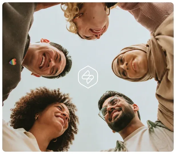 A diverse group of people smiling together in a circle beneath a soft Samata mark.